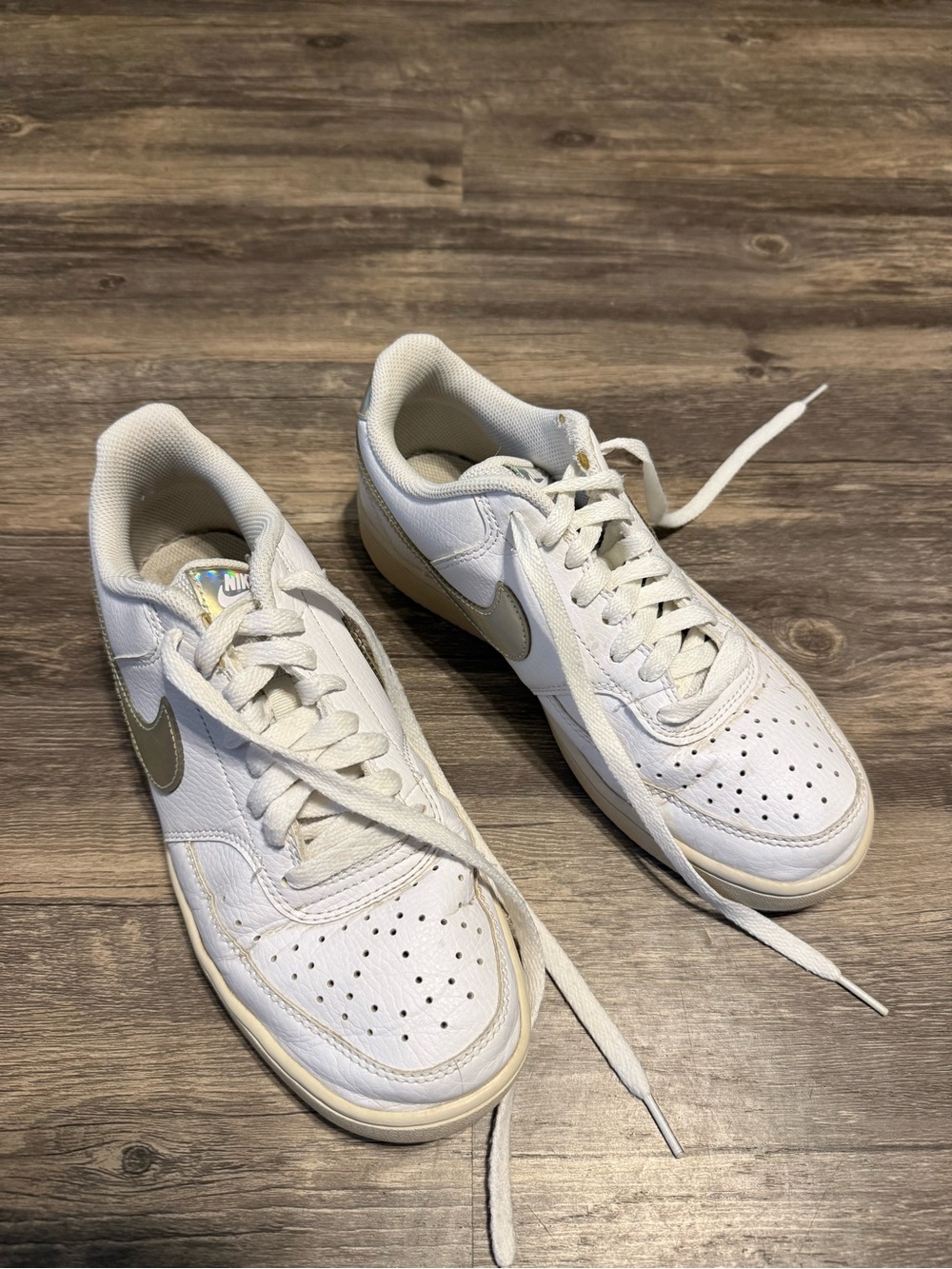 Nike White Sneakers with Metallic Silver Swoosh